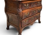 an old chest of drawers with ornate carvings on the drawers
