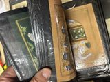 a person holding a wallet with a book inside of it