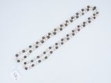 a close up of a rosary with a tag on it