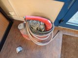 a fire hydrant that has a hose attached to it