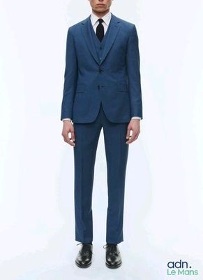 a man in a blue suit and black tie