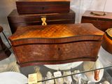 a glass display case with a wooden box on it