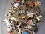 a pile of assorted key chains on a table