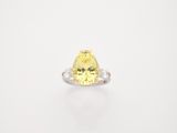 a yellow diamond ring on a white background