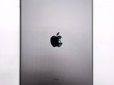 an apple ipad sitting on top of a white table next to a white wall