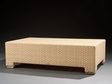 an upholstered bench made of woven fabric on a black background