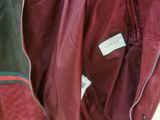 jacket hanging on a rack in a clothing store with a tag on it
