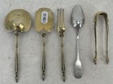 several spoons and spoon knives are lined up on a table