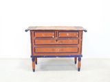 a small wooden chest of drawers with drawers on it