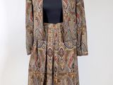 an image of a dress and jacket on a mannequin stand