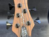 a close up of the headstock of a bass guitar