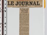an open journal with a piece of paper on top of it