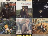 many different album covers on the wall of a room