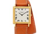 an 18k yellow gold wrist watch with roman numerals