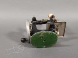 an image of a sewing machine with a green wheel