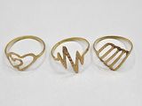 three gold rings, one with a heart and the other with a letter w