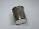 an old silver cup on a white table with a white background