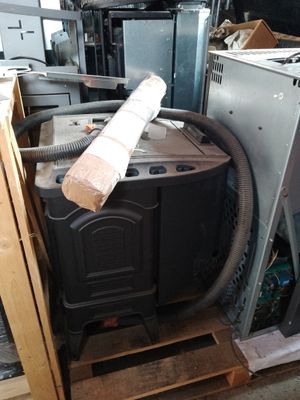 a stack of old appliances in a room with a lot of junk