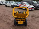 a small yellow machine that is parked in a parking lot