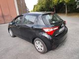 a small black car that is parked in the parking lot
