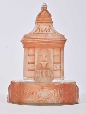 a small fountain with a clock on top of it