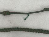two pieces of green rope with a knot on a white surface