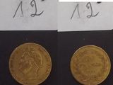deux pièces d'or posées l'une à côté de l'autre sur une feuille de papier