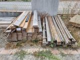 many pieces of wood sitting on the ground next to each other
