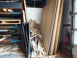 a pile of wood sitting in a garage next to a window