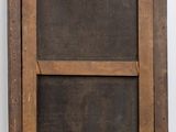 an old wooden frame with a black and brown painting on it