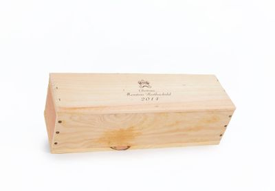 a wooden box with a label on it on a white surface