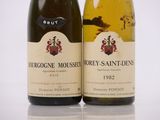 two bottles of wine sitting next to each other on top of a table