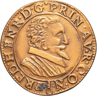 a close up of a gold coin with a man ' s face on it
