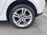 a close up of a tire on a white car