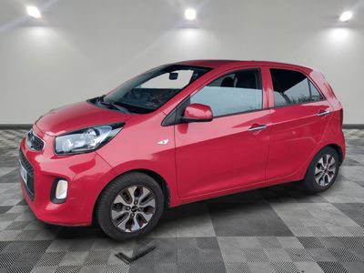 a red car is parked in a room with a checkered floor