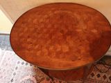a small table with a wooden top on a rug
