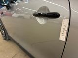 a close up of a car door handle with a sticker on it