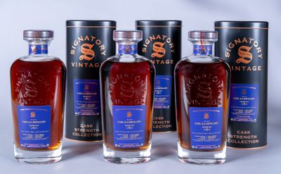six bottles of whisky are lined up on a table