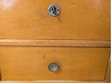 a wooden dresser with two drawers on top of it