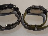 two watches that are sitting on a table