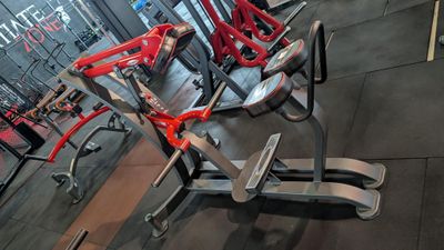 a gym with a row of exercise equipment in it