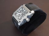 a watch that is sitting on top of a black watch band