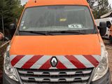 an orange van that is parked in a parking lot
