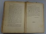 an open book on a table with a white table cloth
