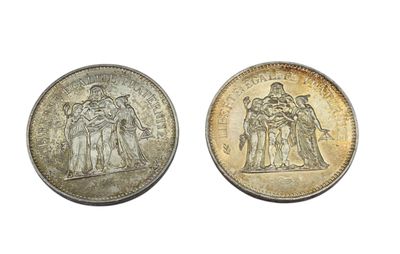 two silver coins with the image of a group of people on them
