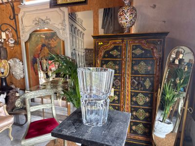 a glass vase sitting on top of a table in a room