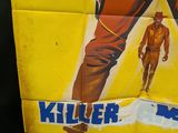 movie poster of a man holding a gun in front of a poster of a man holding a gun