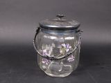 a glass jar with flowers inside of it on a table