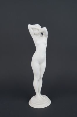 a white statue of a woman holding her head in her hands
