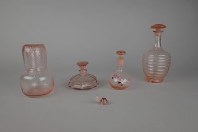 cinq vases en verre différents posés sur une table